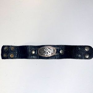 Leather bracket with initials “ARB”